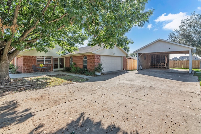 view of front of property featuring a garage and a carport