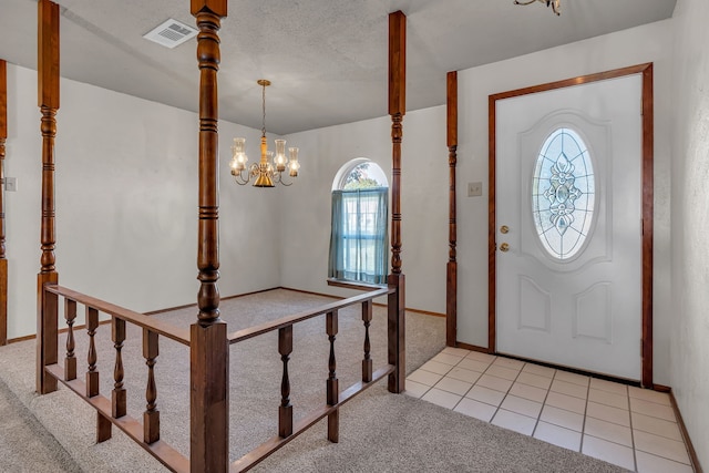 entryway featuring light tile patterned flooring and a chandelier