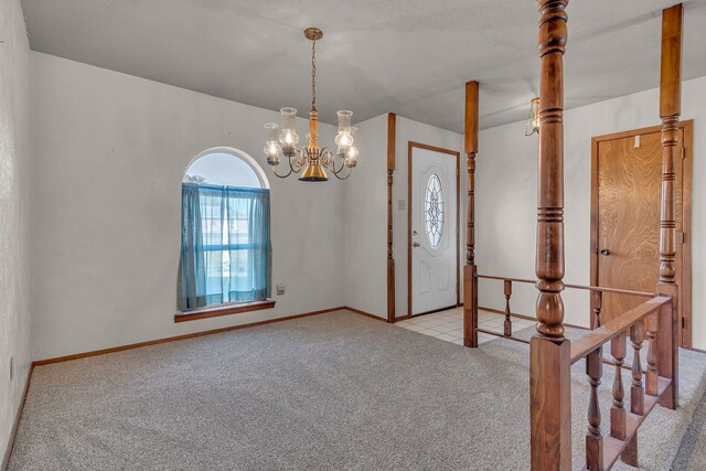 entryway with light colored carpet and an inviting chandelier