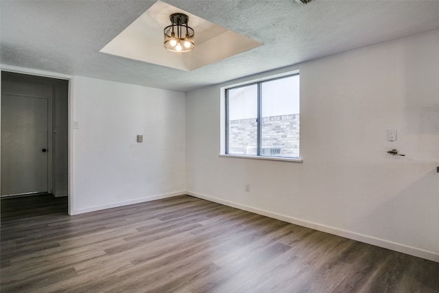 spare room with wood-type flooring and a textured ceiling