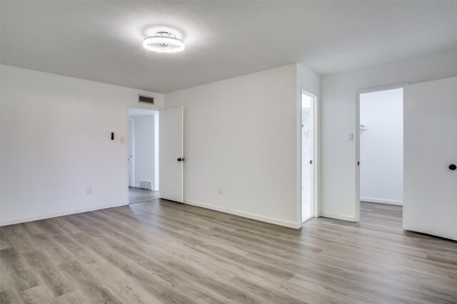 unfurnished room with light wood-type flooring