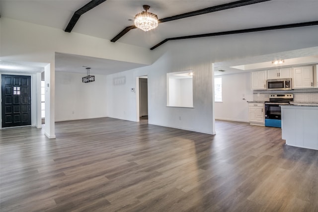 unfurnished living room with dark hardwood / wood-style floors and lofted ceiling with beams