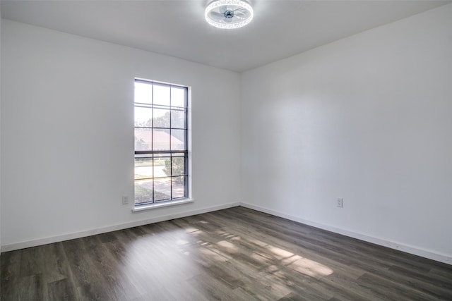 unfurnished room featuring a wealth of natural light and dark wood-type flooring