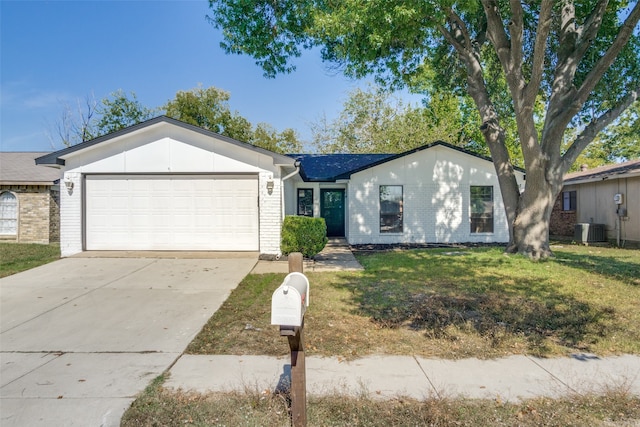 ranch-style home with a garage, central air condition unit, and a front lawn