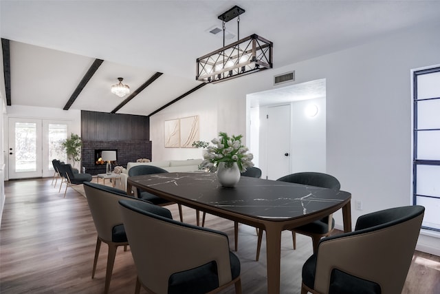 kitchen with white cabinets, appliances with stainless steel finishes, and light hardwood / wood-style flooring