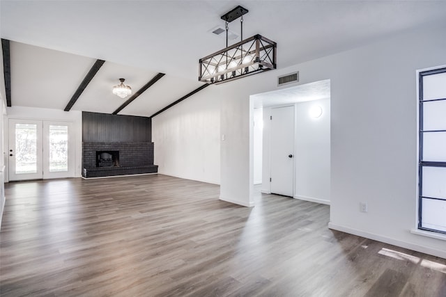 dining room with dark hardwood / wood-style flooring, a raised ceiling, and a notable chandelier