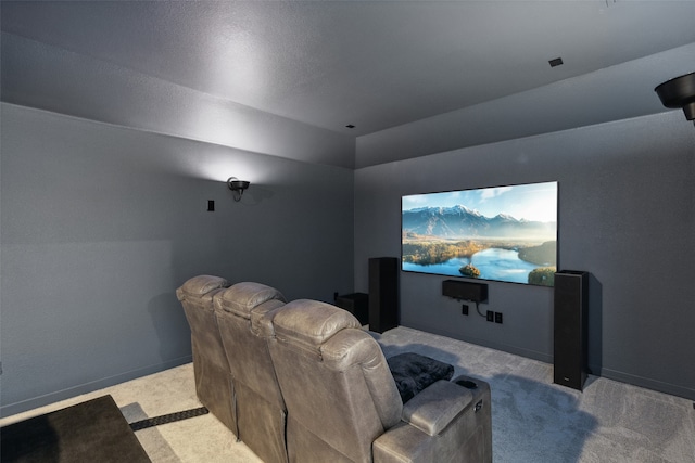 home theater room with light colored carpet