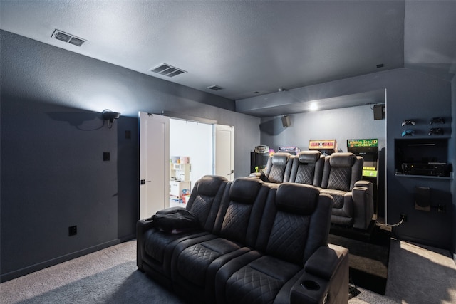 carpeted home theater with a textured ceiling