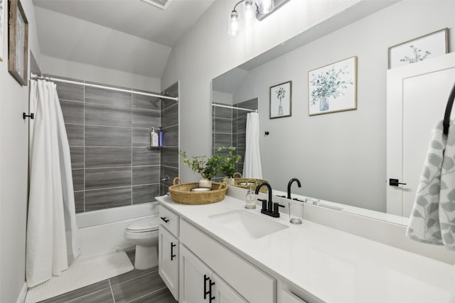 full bathroom featuring shower / bath combo, vanity, tile patterned flooring, toilet, and lofted ceiling