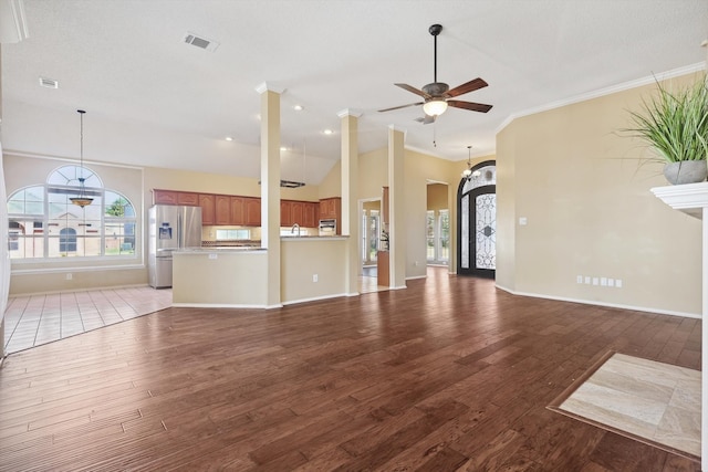 unfurnished living room with a textured ceiling, ceiling fan, crown molding, light hardwood / wood-style flooring, and lofted ceiling