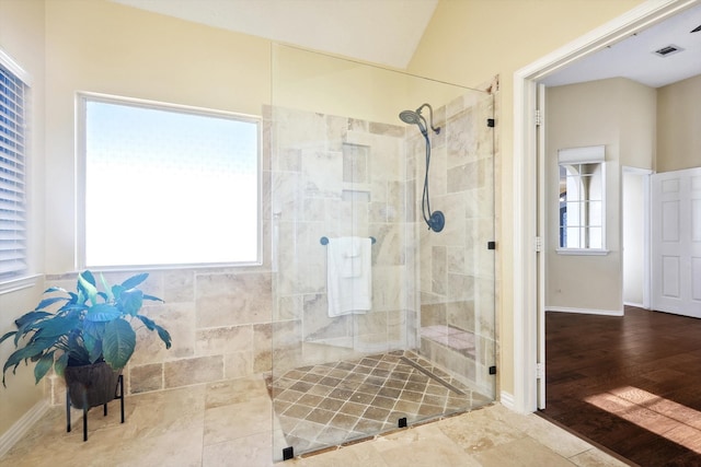 bathroom with wood-type flooring, an enclosed shower, and lofted ceiling