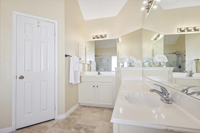 bathroom featuring a shower with door and vanity