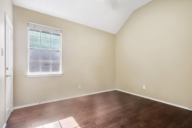 empty room featuring hardwood / wood-style floors and vaulted ceiling