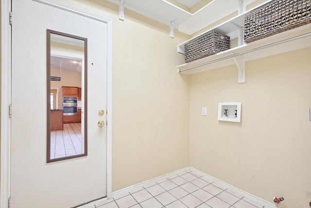 laundry room with gas dryer hookup, light tile patterned flooring, and washer hookup