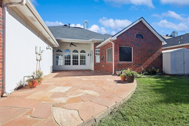 rear view of house with a yard, a patio, and a storage unit