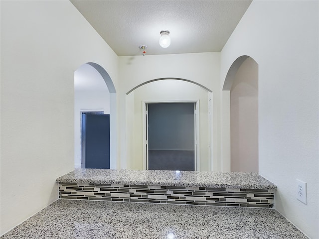 interior space with a textured ceiling