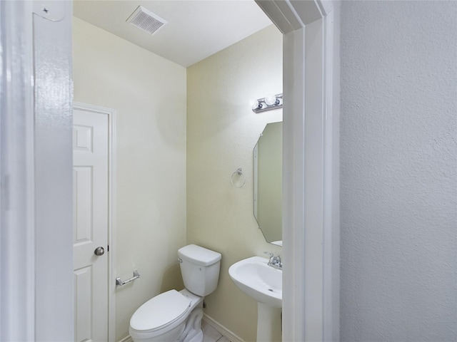 bathroom featuring sink and toilet