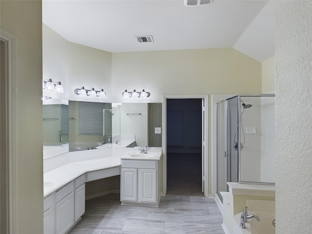 bathroom featuring vanity, lofted ceiling, and walk in shower