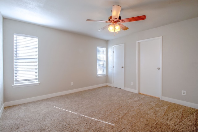 carpeted empty room with ceiling fan