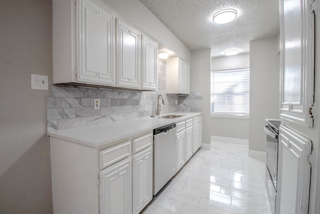 kitchen with sink, stainless steel appliances, a textured ceiling, decorative backsplash, and white cabinets