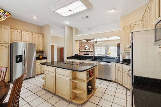 kitchen featuring kitchen peninsula, a kitchen island, light tile patterned floors, and appliances with stainless steel finishes