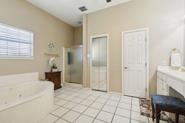 bathroom with tile patterned flooring, vanity, and separate shower and tub