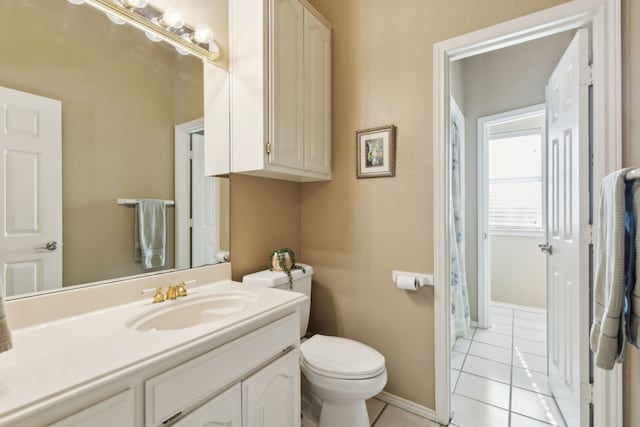 bathroom featuring tile patterned floors, vanity, and toilet