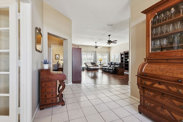 hall featuring light tile patterned floors