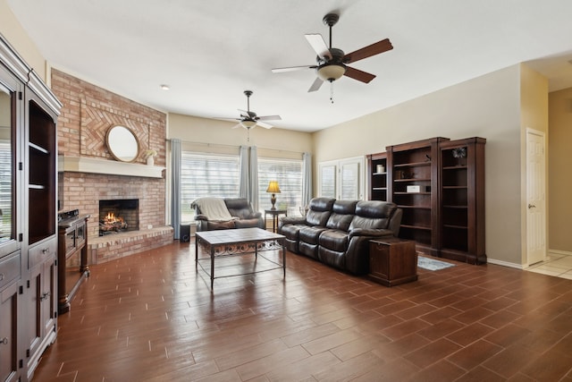 living room with ceiling fan, dark wood-type flooring, and a brick fireplace