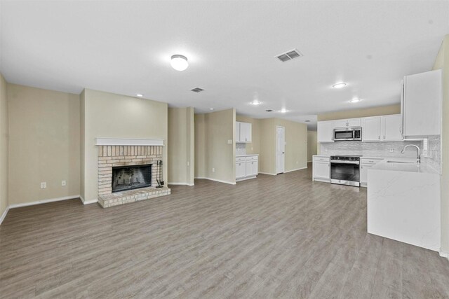 game room with hardwood / wood-style flooring and ceiling fan