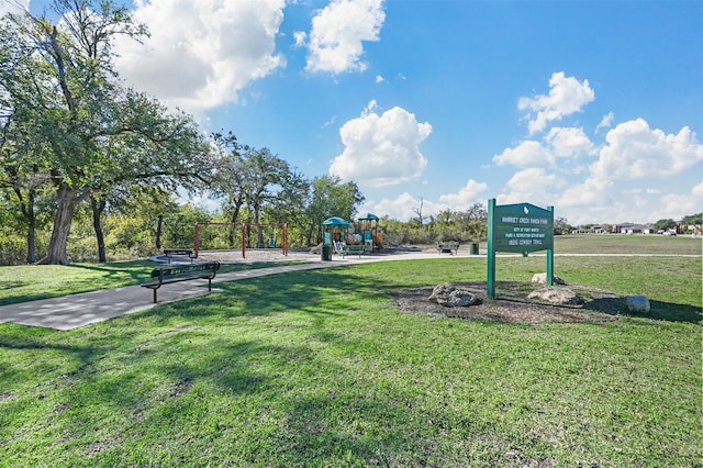 surrounding community featuring a playground and a lawn