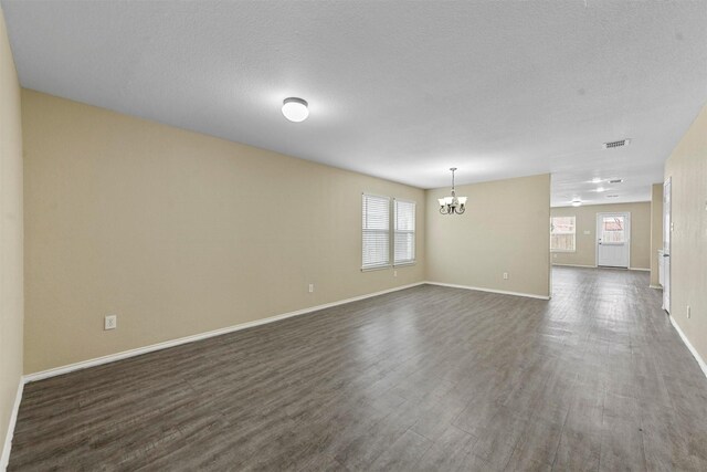 living room with hardwood / wood-style floors and an inviting chandelier