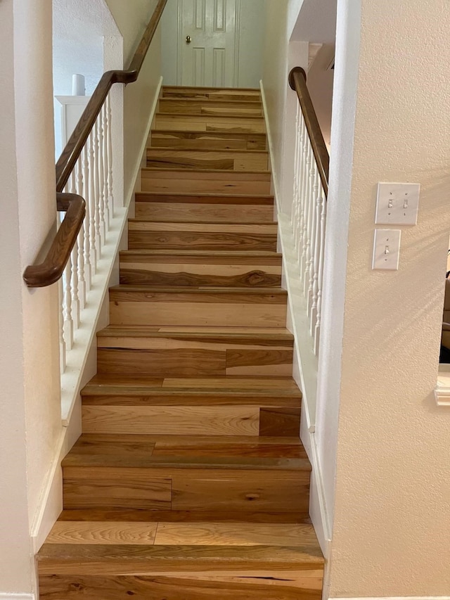 stairway with hardwood / wood-style flooring