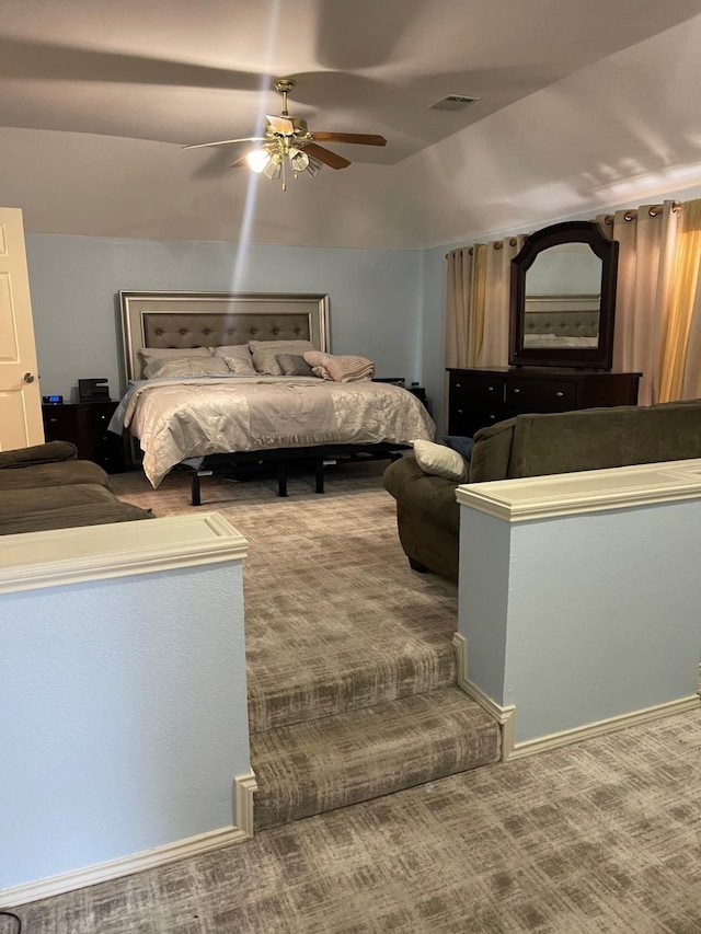 unfurnished bedroom featuring carpet flooring, ceiling fan, and vaulted ceiling