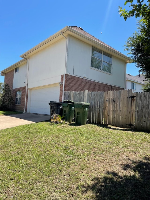 view of property exterior featuring a yard and a garage