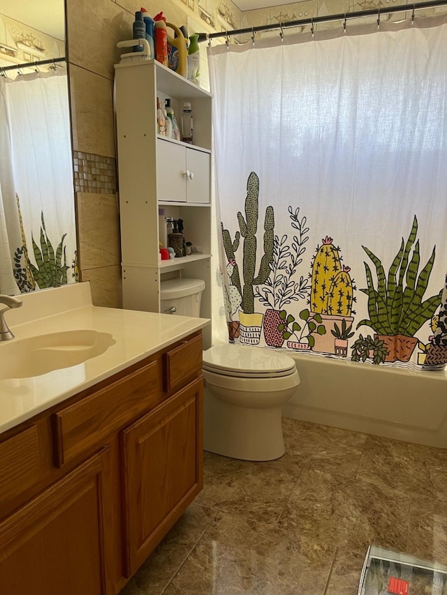 full bathroom with vanity, shower / bath combo, and toilet