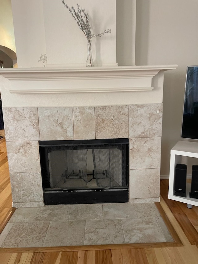 room details with a fireplace and hardwood / wood-style flooring