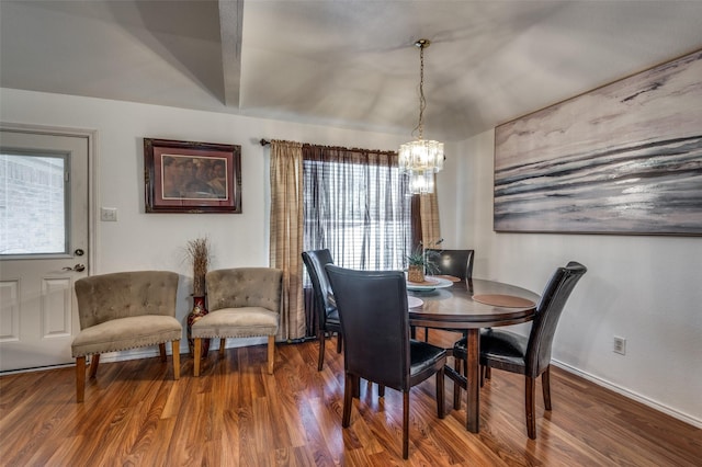 dining space featuring hardwood / wood-style floors and an inviting chandelier