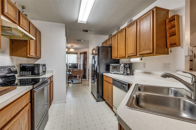 kitchen with sink, black appliances, a textured ceiling, and ventilation hood