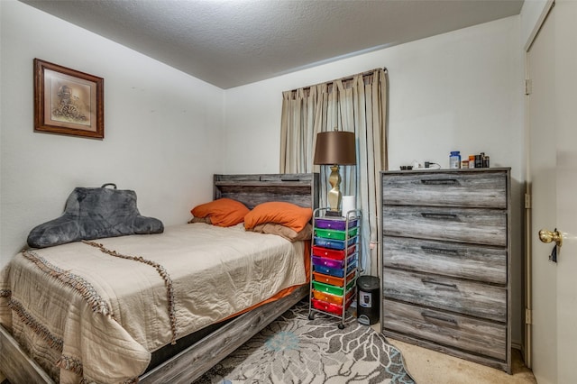 bedroom featuring carpet floors and a textured ceiling