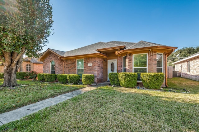 view of front of house with a front yard and central AC