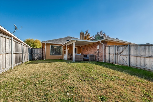 rear view of property with a lawn and an outdoor living space