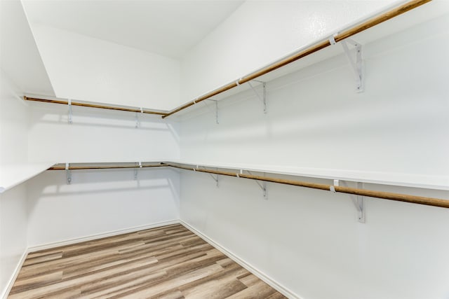 spacious closet with light hardwood / wood-style floors