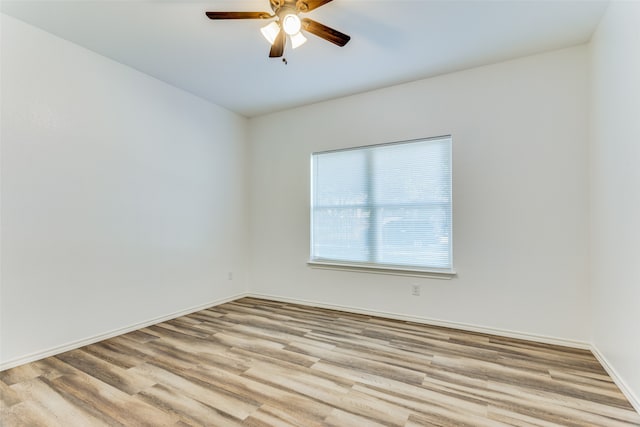 spare room featuring light hardwood / wood-style flooring and ceiling fan