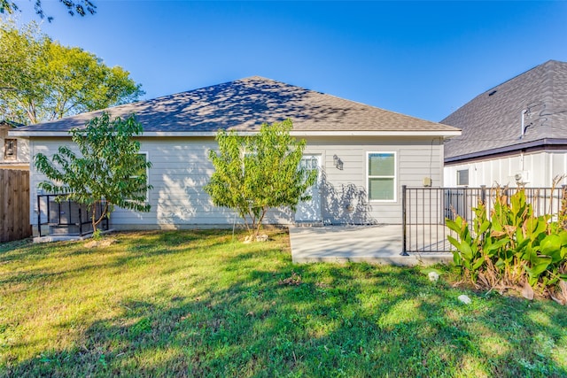 back of property featuring a yard