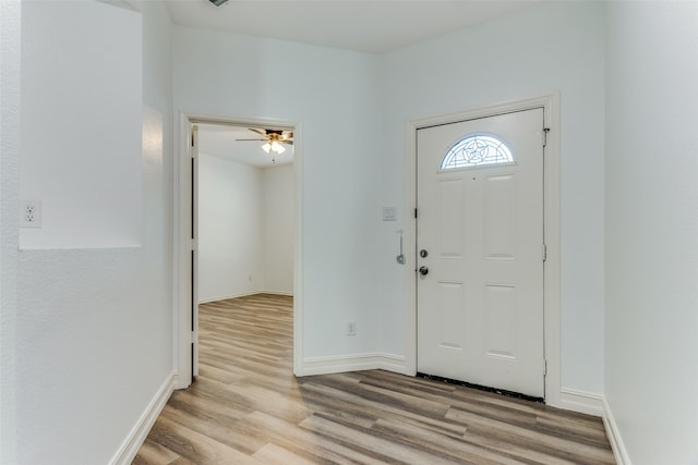 foyer entrance with ceiling fan and light hardwood / wood-style flooring