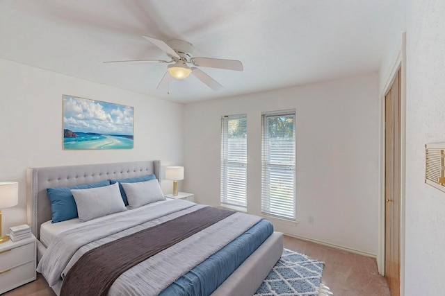 bedroom with light hardwood / wood-style floors and ceiling fan