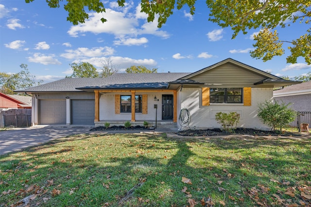 ranch-style house featuring a front yard, a porch, and a garage