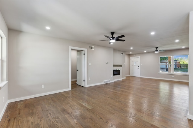 unfurnished living room featuring ceiling fan and wood-type flooring