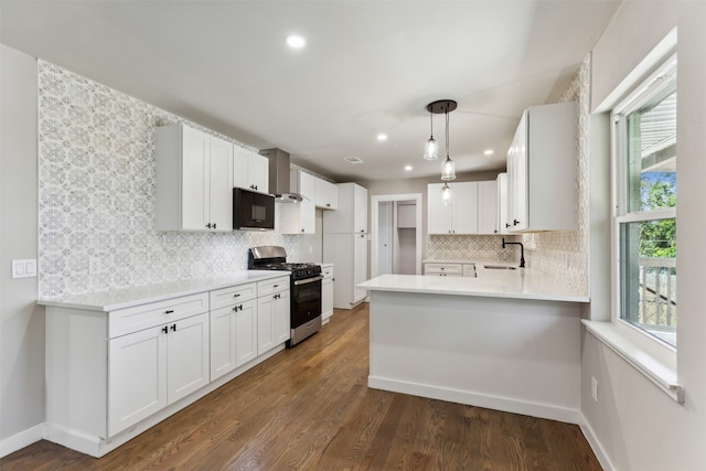 kitchen with pendant lighting, dark wood-type flooring, gas range, plenty of natural light, and white cabinetry